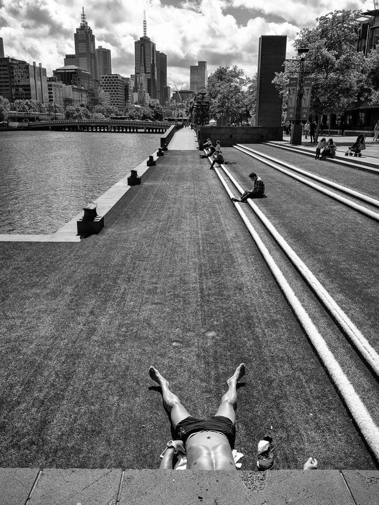 black and white photo of a person sunbathing